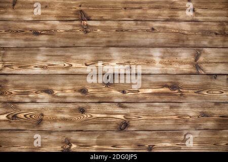 Wooden background. Aged boards by firing and brushing. A beautiful universal natural background from textured boards. Stock Photo