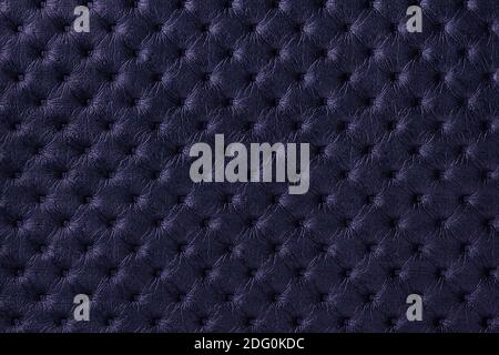 Texture of navy blue leather background with capitone pattern, macro. Dark purple textile of retro Chesterfield style. Vintage fabric violet backdrop. Stock Photo