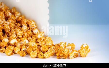 Sweet caramel candy popcorn in a basket light blue background Stock Photo