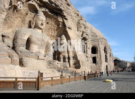 Yungang Grottoes near Datong in Shanxi Province, China. Cave 20, the most famous Buddha statues at Yungang. Wide view with unrecognizable people. Stock Photo