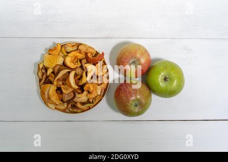 dried apples and fresh on a light wooden background Stock Photo