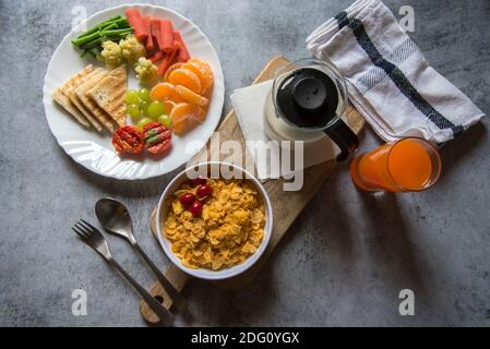 Top view of Healthy breakfast of milk and cornflakes, fruits and juice Stock Photo