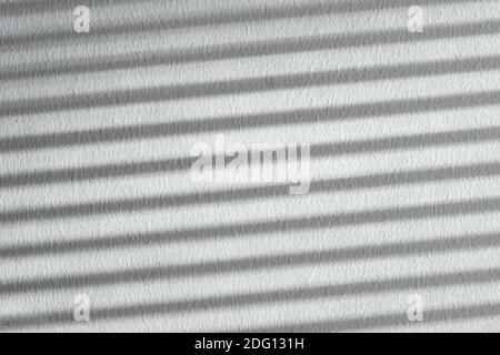 Shadow on a white striped wall. Natural background from blinds. High quality photo Stock Photo
