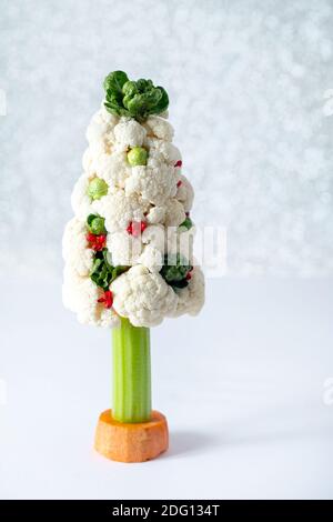 Beautiful vegetable Christmas tree on a silver bokeh background. Vegetarian Christmas food concept. Stock Photo