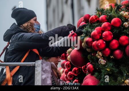 London, UK. 7th Dec, 2020. Final preparations are made to the Christmas decorations on the facade at Annabel's, Berkeley Square. Credit: Guy Bell/Alamy Live News