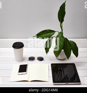 Perfect Minimal Work Desk with Tablet, Smartphone, Note and Coffee. Office Freelancer Table. Stylish Work Place with necessary Accessories Stock Photo