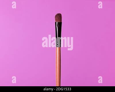 Makeup brushes, everyday make-up tools. Cosmetic essentials on bright blue background, closeup Stock Photo