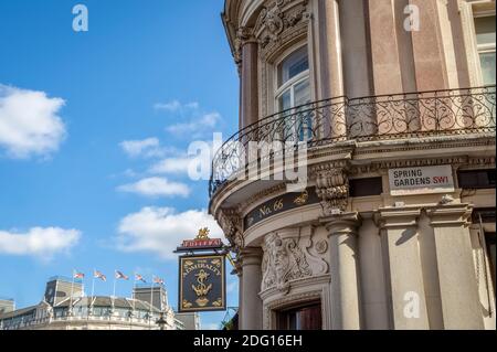 London, UK - March 25, 2019: Closeup of famous Admiralty pub bar with entrance and nobody red Fuller's sign by Trafalgar Square. Stock Photo