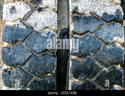 Tire treads on the rubber tire of a large construction machine. Close up. Stock Photo