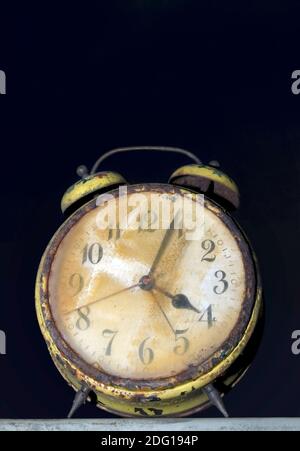 Rusty Broken Clock Dirty old broken rusty alarm clock. Broken dial. Red body violet ...