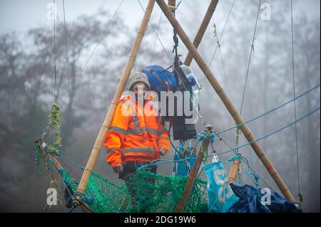 Denham, Buckinghamshire, UK. 7th December 2020. Veteran eco activist Dan Hooper known as Swampy is currently locked onto a huge bamboo structure in the River Colne in Denham. Activists put the 'beacon of truth' in place early this morning. HS2 have already felled many mature trees in Denham Country Park ahead of the bridge construction. Anti HS2 Rebellion activists at the Denham Ford Wildlife Protection Camp are are trying to stop the bridge from going across the River Colne today and further woodland destruction by HS2. Credit: Maureen McLean/Alamy Live News Stock Photo