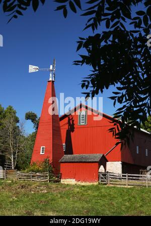 Historic Red Barn. The barn was built in the 1880's and featured a unique enclosed windmill tower. Carriage Hill Metropark, Huber Heights or Dayton, O Stock Photo