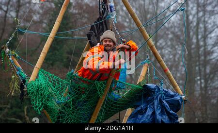 Denham, Buckinghamshire, UK. 7th December 2020. Veteran eco activist Dan Hooper known as Swampy is currently locked onto a huge bamboo structure in the River Colne in Denham. Activists put the 'beacon of truth' in place early this morning. HS2 have already felled many mature trees in Denham Country Park ahead of the bridge construction. Anti HS2 Rebellion activists at the Denham Ford Wildlife Protection Camp are are trying to stop the bridge from going across the River Colne today and further woodland destruction by HS2. Credit: Maureen McLean/Alamy Live News Stock Photo