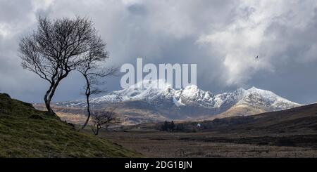 A brief moment of morning light on a snow capped Blabheinn, near Torrin, Isle of Skye, Scotland Stock Photo