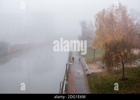 London, UK- December 2020 : Mist and fog on the Waterworks River looking toward the Aquatic Centre, Queen Elizabeth Olympic Park Stock Photo