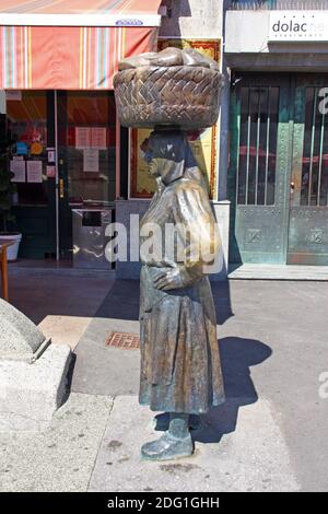 ZAGREB, CROATIA – JULY 28, 2020: Statue of countrywoman with woven basket on her head on Dolac market in Zagreb, Croatia Stock Photo