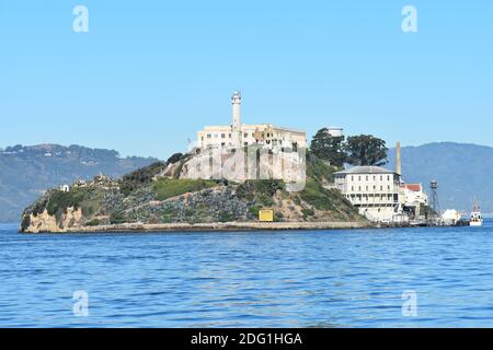 Alcatraz Island  on a clear sunny day from San Fransisco Bay.  The cell house and wardens house are visible on top of the hill. California, USA Stock Photo