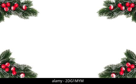 Decorative Christmas snowy frosted fir twigs with red berries sticking out in the corners. Isolated on white background. Empty copy space in the middl Stock Photo
