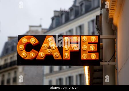 The sign from light bulbs with the word CAFE on town street. Stock Photo