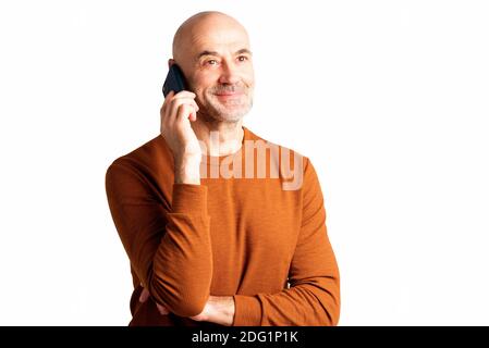 Portrait shot of middle aged man standing at isolated white background and making a call. Copy space. Stock Photo
