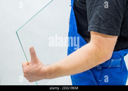 A worker holding a glass in his hands Stock Photo