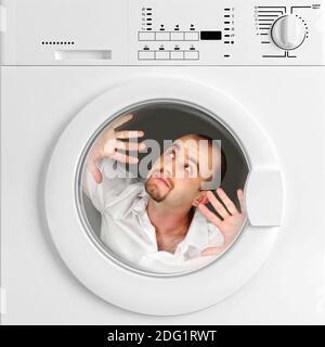 Funny portrait of man inside washing machine Stock Photo