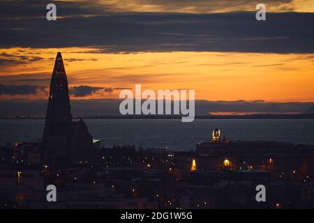 Beautiful night dusk view of Reykjavik, Iceland, aerial view with Hallgrimskirkja lutheran church, with scenery beyond the city, Esja mountain and Fax
