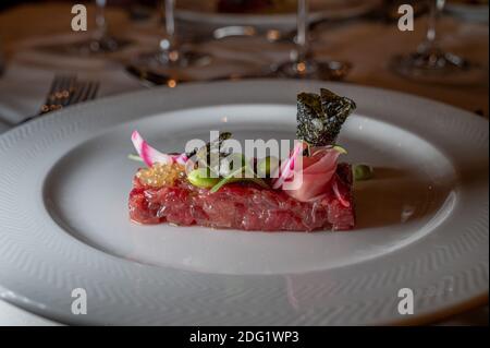 Fish tartar with salad. Fresh tuna fish tartare with tasty vegetables. Stock Photo