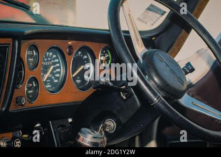 Dashboard Of A 1970's Triumph Stag Mark 2 Classic Sports Car Showing Steering Wheel And Instrument Panel With Speedometer And Rev Counter Stock Photo