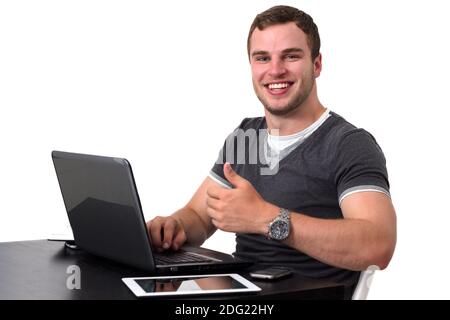 Young happy man working on pc Stock Photo