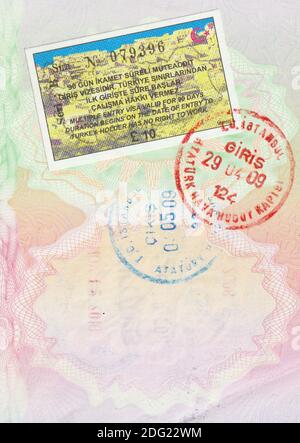 UK passport page with entry and exit stamps for Turkey, plus tourist visa permit, from Istanbul Ataturk airport in 2009 Stock Photo