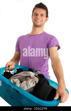 Young man doing the laundry Stock Photo