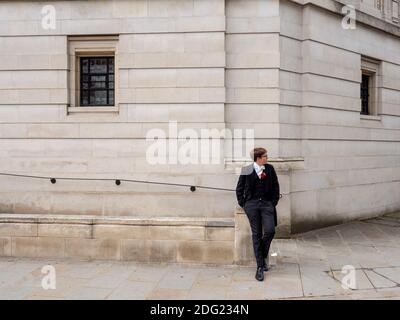 An Eton College school boy with a flower in his buttin hole for the fourth of June Founders Day celebrations. Stock Photo