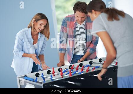 Group of students playing table soccer in the campus Stock Photo