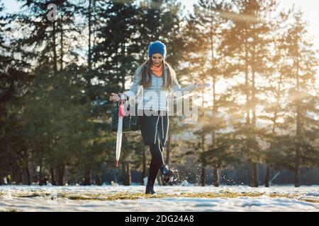 Woman walking thru slushy snow Stock Photo