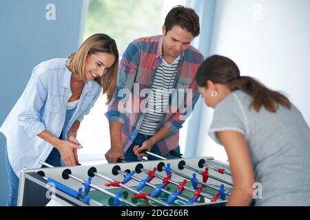 Group of students playing table soccer in the campus Stock Photo