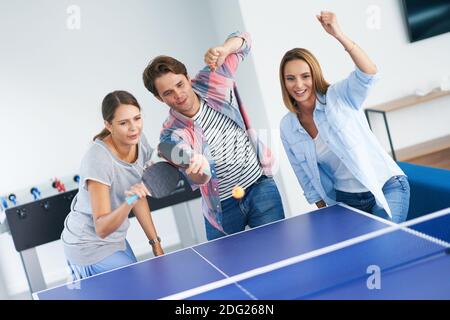 Group of students playing table tennis in the campus Stock Photo