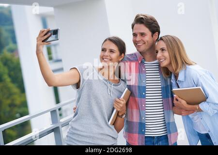 Group of students using smartphone in the campus Stock Photo