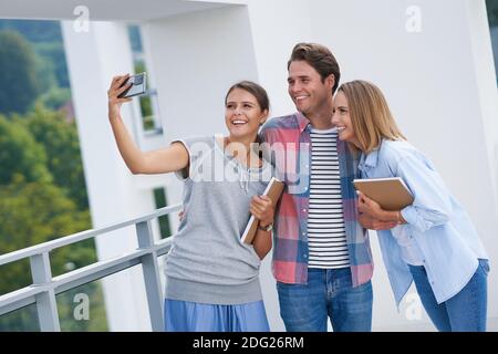Group of students using smartphone in the campus Stock Photo