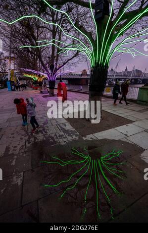 London, UK. 7th Dec, 2020. David Ogle's Lumen - A row of the Riverside Plane trees illuminated with glowing neon flex creating a multicoloured canopy over the heads of pedestrians - Winter Light: a new open-air exhibition animating the Southbank Centre site with luminous artworks. It includes over 15 artworks and new commissions that make use of light, colour and animation. They will remain on display until the end of February. Credit: Guy Bell/Alamy Live News Stock Photo