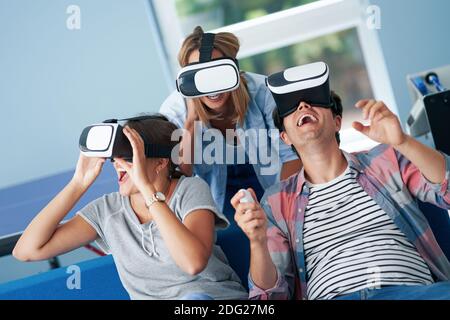 Couple of students playing video games in the campus Stock Photo