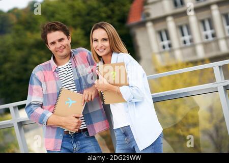 Couple of students standing together in the campus Stock Photo