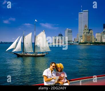 New York 1985, tourists couple, river cruise, Pioneer schooner sail boat, WTC World Trade Center twin towers, Manhattan, New York City, NY, NYC, USA,