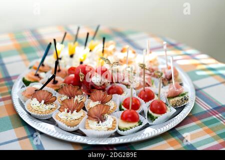 The buffet at the reception. Assortment of canapes on a table. Banquet service. Catering food, snacks with different types of cheese, ham, salami, pro Stock Photo