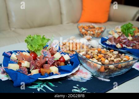 The buffet at the reception. Assortment of canapes on a table. Banquet service. Catering food, snacks with different types of cheese, ham, salami, pro Stock Photo