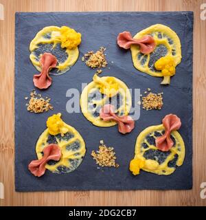 Italian gourmet dish - Homemade farfalle pasta with breadcrumbs and yellow cauliflower cream Stock Photo