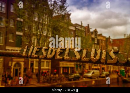 Amsterdam. Bridge sign over city canals and buildings in spring season Stock Photo