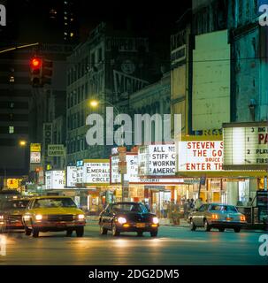 New York 1985, 42nd street, night, cars traffic, illuminated movie theatres marquees, midtown Manhattan, New York City, NY, NYC, USA, Stock Photo