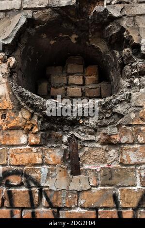 Old brick wall with large hole smashed through Stock Photo - Alamy
