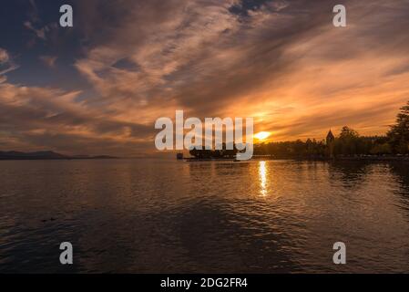 Sunset on Lake Geneva with reflections in the water and clouds. Golden hour Stock Photo